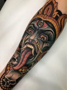 a man's arm with a tattoo on it and an image of a demon