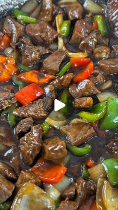 beef and peppers are being cooked in a wok