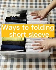 a woman's hands holding folded clothes in a plastic container with the words, ways to folding short sleeves