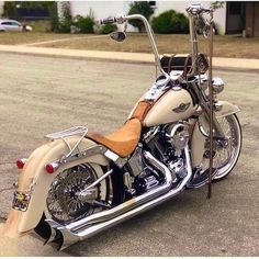 a white and tan motorcycle parked on the street