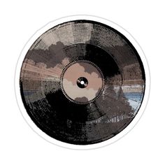 a black and brown record on a white background with an image of clouds in the sky