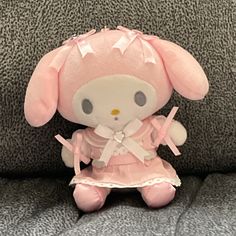 a pink stuffed animal sitting on top of a couch