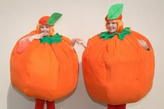 two people in costumes made to look like pumpkins