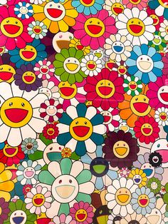 a large group of colorful flowers with faces on them