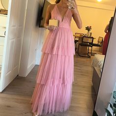 a woman in a pink dress taking a selfie