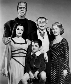 an old black and white photo of people dressed up as the addams for halloween