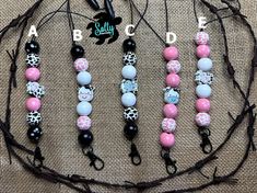 four different necklaces with black, white and pink beads on them are arranged in a circle