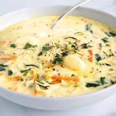 a white bowl filled with soup on top of a table