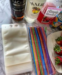 strawberries, orange juice, and other ingredients are laid out on a counter top