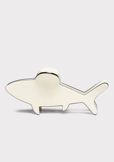 a white fish shaped object sitting on top of a table