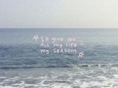 a message written in the sand next to the ocean