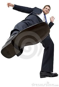 a man in a suit jumping up into the air