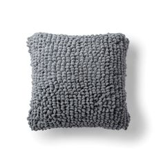 a gray pillow on a white background