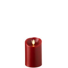 a small red candle with a white flame