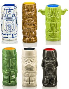 four star wars mugs are shown in different colors and designs, each with a character