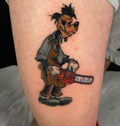 a cartoon character with a chainsaw on his leg is seen in this tattoo design