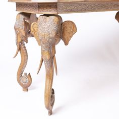 an elephant carved into the side of a table