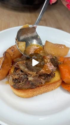 a person is spooning food on top of a white plate with carrots and potatoes