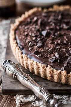 a chocolate pie on a wooden cutting board