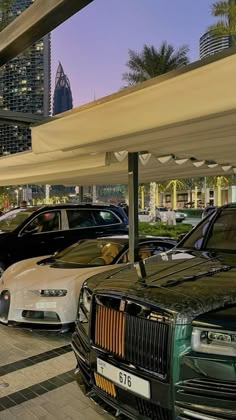 several cars are parked under an awning