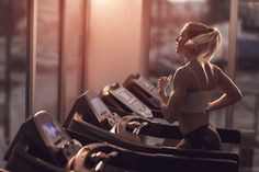 a woman is running on a treadmill