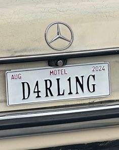 a mercedes badge is shown on the back of a car's license plate that reads, darling