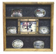 a wooden frame with pictures and other decorative items on the bottom shelf in front of it