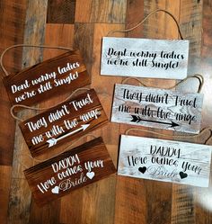 four wooden signs with different sayings on them