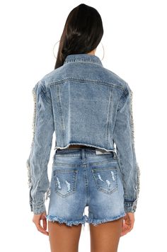 The Diamonds Dancing Cut Out Crop Denim Jacket features a sturdy denim fabrication, cropped length, raw hem, silver hardware, sleeve cut outs with rhinestone fringe embellishments, two front pockets, and a button up closure. (all measurements are approximate, measured from size small) - 100% Cotton  - Hand Wash Cold  - 15.5” Shoulder to Hem  - 24.5” Sleeves - Model is wearing size small - Imported  Product ID: 229429 Crop Denim Jacket, Rhinestone Fringe, Cropped Denim Jacket, Cropped Denim, Diamond Cut, Cut Outs, Silver Hardware, Diamond Cuts, Embellishments