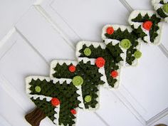 crocheted christmas tree decorations hanging on the wall