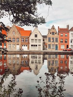 some buildings are reflected in the water