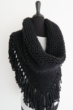 a black knitted scarf on a mannequin