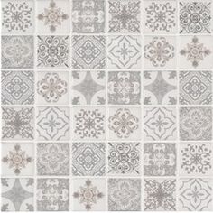 a white and gray rug with many different designs on it