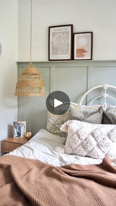 a bed room with a neatly made bed and two pictures on the wall above it