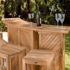 three wooden stools with wine bottles and glasses next to them on a white background