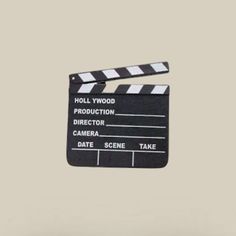 a black and white movie clapper with the words hollywood written on it's side