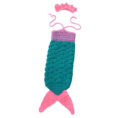 a crocheted mermaid tail is hanging from a hook on a white background with pink and blue trim