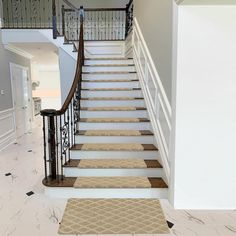 a staircase with carpeted steps leading up to the second floor