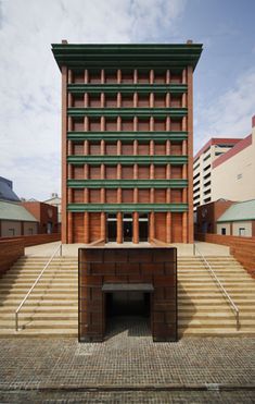 a building with stairs leading up to it and a tunnel in the middle between two buildings