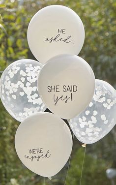 white balloons with the words she said yes written on them