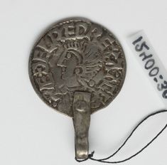 an old silver coin with a string attached to it