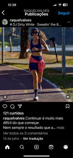 a woman running down a street next to a tree