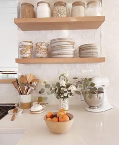 the kitchen counter is clean and ready to be used for cooking or baking, as well as some flowers in a bowl