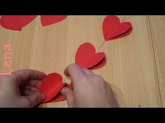 someone is making hearts out of paper on the table