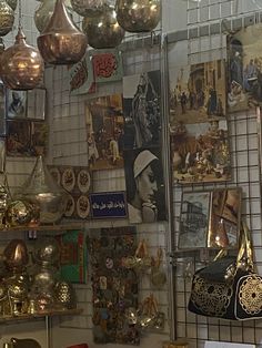 there are many items on the wall in this room, including purses and hats