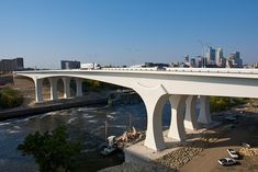 a bridge over a river with cars driving on it