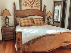 a large bed sitting inside of a bedroom on top of a hard wood floor