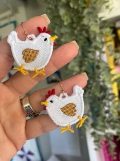 two handmade earrings with chickens on them