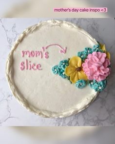 there is a cake that says mom's slice with flowers on the bottom and pink, blue, yellow and green icing