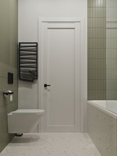 a white toilet sitting next to a bath tub in a bathroom